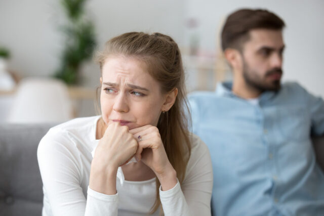 Close up of young wife crying after fight with husband post-breakup syndrome