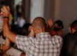Biblical men's support group praying together in a circle